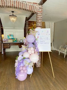 balloons and streamers decorate the entrance to a baby shower