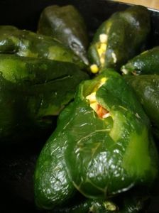 some green peppers are in a black bowl