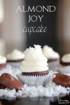 chocolate cupcakes topped with white frosting on top of coconut flakes and the words, almond joy cupcake