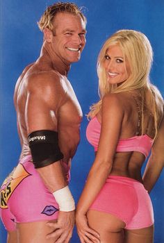 a man and woman in pink bikinis posing for a photo with their arms around each other