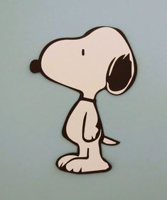 a sticker of a cartoon snoopy sitting on the ground