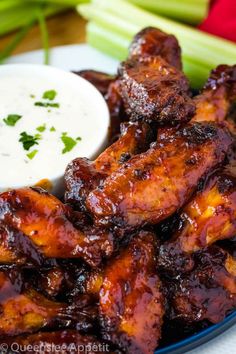 chicken wings with ranch dressing and celery sticks on the side, ready to be eaten