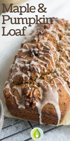 a loaf of maple and pumpkin loaf on a cooling rack with the words maple and pumpkin loaf