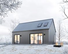 a small house in the middle of a snowy field