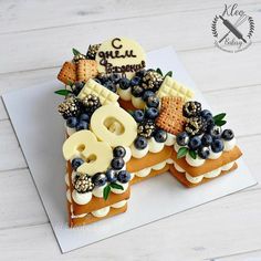 a cake with blueberries, waffles and cheese on it