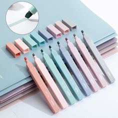 several different colored toothbrushes sitting next to each other on top of a book