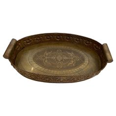 an ornately decorated brass tray with handles