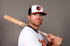 a baseball player poses for a photo with his bat