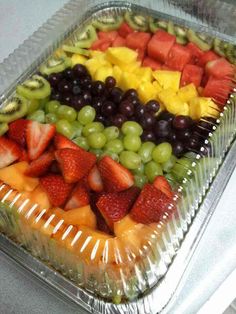 a tray filled with lots of different types of fruit on top of plastic wrappers