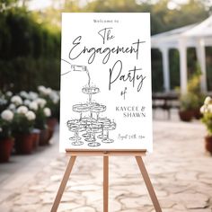 the engagement party sign is on an easel in front of some potted plants