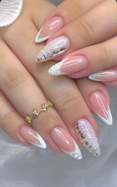 a woman's nails with white and pink designs on them