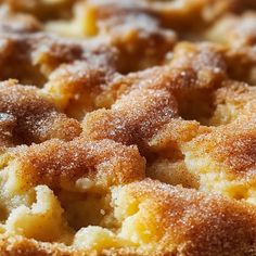 a close up view of some food with sugar on top and crumbs all over it