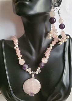 "Beautiful gemstone Amethyst and Rose Quartz that blend so well in colors of purple and pink. Amethyst has a cleansing energy and are known to instill feelings of understanding, calmness. Healing properties against negative energy. Rose Quartz is the stone of universal love. Purifies and opens the heart at all levels to promote self love, deep inner healing. Large Rose Quartz pendant measures 1.5' in diameter, 1/4' thickness, with Amethyst chip at the bottom of round pendant 2 large Amethyst pur Pink Jewelry For Meditation, Pink Amethyst Spiritual Necklace, Pink Amethyst Spiritual Necklaces, Round Rose Quartz Jewelry For Meditation, Rose Quartz Jewelry For Meditation, Pink Amethyst Jewelry With Gemstone Accents, Pink Natural Gemstones For Jewelry Making, Pink Amethyst Round Beads Jewelry, Pink Natural Stones For Jewelry Making