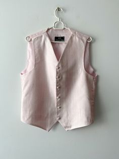 "Vintage Light pink Gentleman's Formal Vest Steampunk Groom pink Vest Mens Waistcoat Classic Mens Vest Summer formal Vest Size Medium Label size: M Measurements:  (lying flat): Length: 23\"/ 58.5 cm *Pit to pit: 21\"/ 53.5 cm *Waist: 20.5\"/ 52 cm * measurements taken while garment lay flat, to get girth you need to double measurements. Please check measurements to insure a proper fit. Remember to allow yourself some extra room for movement. You can compare these with something from your closet that fits you well. This vest will come to you freshly laundered and ready to wear. Please feel free contact me if you need additional measurements or have any questions Condition: great Vintage Condition SHIPPING * I ship worldwide via Priority mail (Latvijas Pasts) from Latvia (EU). * I ship from Pink Fitted Vest For Winter, Formal Vest, Men's Waistcoat, Mens Waistcoat, Pink Vest, Vests Mens, Mens Vest, Vest Outfits, Vintage Lighting