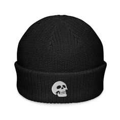 a black knitted skull hat with a white skull on the front