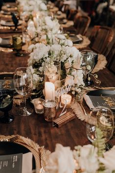 the table is set with candles, flowers and napkins for an elegant wedding reception