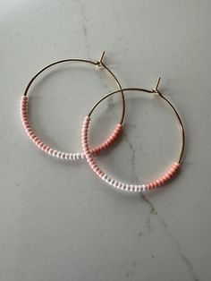 *Medium Sized Hoop Earrings *Three Shades Coral Pink Seed Beads on Gold Hoop *Circle Diameter Approximately 1 3/8" (35mm) These handmade earrings are simple and delicate with dainty coral pink glass seed beads in three shades. They are super lightweight and add the perfect subtle pop of color to your look. They will arrive beautifully packaged and make a perfect gift! Seed Bead Hoop Earrings, Bead Hoop Earrings, Beaded Hoop Earrings, Beaded Hoops, Pink Glass, Jewelry Earrings Hoops, Gold Hoop, Gold Hoop Earrings, Coral Pink