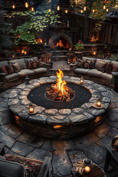 an outdoor fire pit with lit candles around it