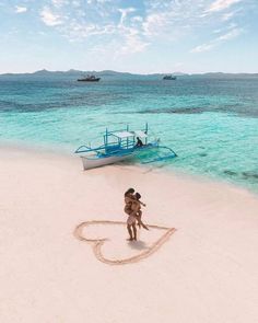 a person on the beach with a boat in the background