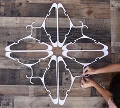 a person is working on a piece of art that looks like an ornament