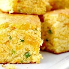 several cornbread muffins stacked on top of each other in a white plate