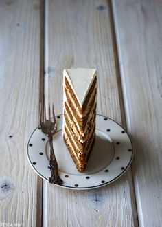 a piece of cake sitting on top of a plate next to a fork and knife