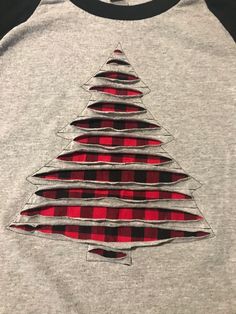 a red and black shirt with a christmas tree on the front is made out of flannel