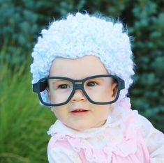 a baby wearing glasses and a blue hat