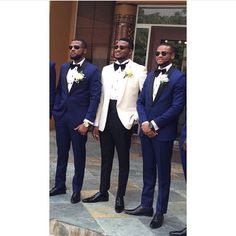 three men in tuxedos standing next to each other wearing sunglasses and bow ties