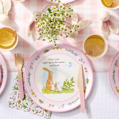 a table set with plates, cups and utensils for easter bunny themed tea party