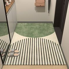 a bathroom with a striped floor and green rugs on the floor, along with a pink purse