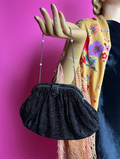 This is a really pretty French evening bag.  It is entirely covered in black micro beads, including the frame.  It has a lift and pull tab to open it.  The frame is silver tone.  It has a chain handle interspersed with little pearls.  The interior is a grey satin.  There is an internal pocket which would have held a mirror but that is missing.  It is stamped "Made in France" in gold on the front of the pocket. It will fit most phones (It fits my iPhone 13).  I am not sure it will fit a huge phon Beaded Purses, Stamp Making, Packing Material, Just The Way, Clutch Handbag, Evening Bags, Purses And Handbags, Satin, Art Collection