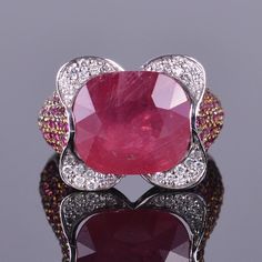 A unique and beautiful 13.07 carat Ruby surrounded by .30 carats of white diamonds. Placed in a pave setting of 5.11 carats of gorgeous rubies. All tastefully set in 18k white and yellow gold. Red Oval Diamond Ring With Pave Setting, Luxury Red Ring With Pave Setting, Luxury Red Diamond Ring With Single Cut Diamonds, Luxury Diamond Ruby Ring, Luxury Ruby Ring With Diamonds, Luxury Ruby Halo Ring, Oval Ruby Ring With Pave Setting, Luxury Ruby Diamond Ring With Pave Setting, Luxury Ruby Jewelry With Pave Setting