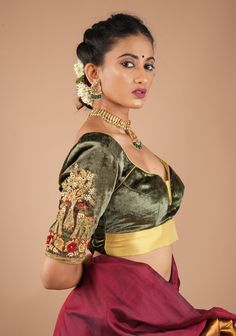 This stunning blouse, crafted from luxurious patina gray velvet, features intricate Zardosi Meenakari handwork, combining traditional embroidery with colorful hand embroidery accents. Designed to be versatile, it can be paired elegantly with both sarees and lehengas, making it a perfect mix and match piece for various festive occasions and weddings. The rich texture and detailed craftsmanship ensure that this blouse stands out as a statement of sophistication and style. Need minor customizations such as altering the sleeve length or neckline? Or if you are looking for a custom size. Ask us and we will try our best to make it happen! SIZE GUIDE : To determine your blouse size, please measure around the fullest part of your bust line using a measuring tape. Your bust measurement will corresp Blouse For Saree, House Of Blouse, Women Saree, Tamil Girls, Velvet Blouse, Traditional Embroidery, Glamour Beauty, Wedding Blouse, Velvet Blouses