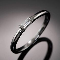 an engagement ring with a baguette cut diamond