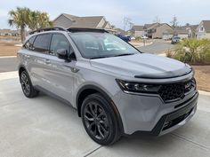 a grey suv parked in front of some houses