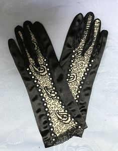 "5 Styles of Vintage Satin Black Gloves. First is a very different short black satin glove with lace insert and 2 rows of rhinestones from fingers to top of glove. So stylish ! Second is a long glove- unique style with open design and gorgeous lace appliques, iridescent black pearls and sequins. These gorgeous gloves are 17\" long - Third is a short satin glove with a stylish black bow and 3 black pearls. Next is black satin fingerless shirred mitt glove for when you want to show off your nails Fitted Costume Accessories For Halloween Evening, Fitted Winter Costume Accessories For Party, Fitted Winter Party Costume Accessories, Winter Party Fitted Costume Accessories, Fitted Black Costume Accessories For Party, Black Costume Accessories For Party, Black Lace Gloves, Iridescent Black, Short Satin