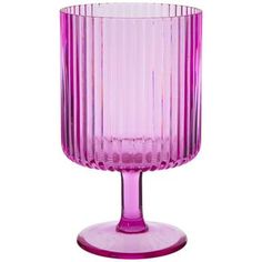 a pink glass vase sitting on top of a table