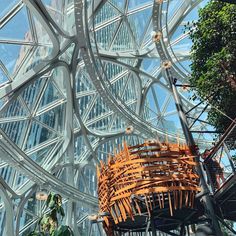 the inside of a building that has a large metal structure with wooden slats on it