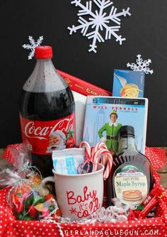 a christmas gift basket with coca cola, candy, candies and other holiday treats