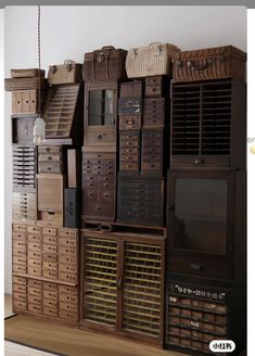 a bunch of wooden crates stacked on top of each other in front of a white wall