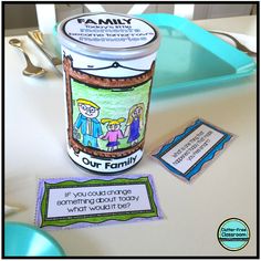 an ice cream cup is sitting on a table with some magnets around it that say family