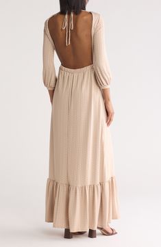 A textured fabric subtly defines this modest maxi dress styled with a gathered three-quarter length sleeve and ruffle-trim skirt. High square neck Three-quarter length sleeves Back tie detail 90% modal, 10% spandex Machine wash, dry flat Made in the USA Feminine Beige Maxi Dress With Ruffle Hem, Cream Maxi Dress With Ruffle Hem, Beige Feminine Maxi Dress With Ruffle Hem, Modest Maxi Dress With Ruffles, Modest Ruffled Maxi Dress, Elegant Flowy Maxi Dress With 3/4 Sleeves, Modest Flowy Ruched Maxi Dress, Modest Ruched Maxi Dress, Chic Flowy Maxi Dress With 3/4 Sleeves