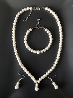 "SET : 1 necklace - 1 bracelet - 1 pairs earrings *Necklace : This pearl necklace is made with 2 different size ivory glass pearls ( 8mm ad 10mm) and rondelle spacer beads. Necklace: 19\" Extension chain: 3\" The necklace can be lengthened or shortened free of charge if you let me know while placing the order.  *Bracelet : This bracelet is made with ilight vory glass pearls 8mm, 10mm and rondella spacers beads (8mm). Bracelet : 8\" (including claps) Extension chain : 2\" The bracelet can be leng Wedding Jewellry, Pearl Wedding Jewelry Sets, Ivory Pearl Necklace, Bride Jewelry Set, Pearl Jewelry Set, Pearl Jewelry Wedding, Crystal Jewelry Sets, Bride Jewelry, Pearl Jewelry Sets