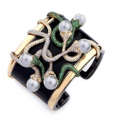 This 18K Yellow Gold Diamond Tsavorite Bracelet features unique yellow gold and black enamel highlighting pearls, Diamonds, and tsavorite to add sophistication and style. Tsavorite Garnet, Garnet Jewelry, Classy Jewelry, Crocodiles, Cz Jewelry, Elegant Bracelet, Bracelet Cuff, Bracelets Jewelry, Lizards