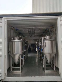 the inside of a shipping container filled with metal tanks