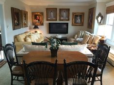 a living room filled with furniture and a flat screen tv mounted to the side of a wall