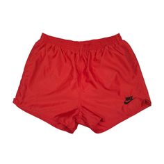 a pair of red shorts with black nike logo on the front and side, sitting against a white background