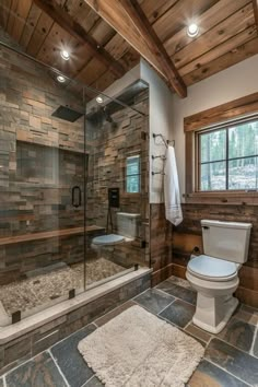 a bathroom with stone walls and flooring