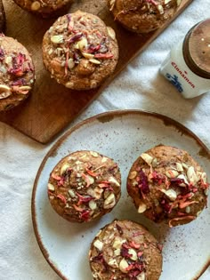 some muffins are on a plate next to a cup of coffee